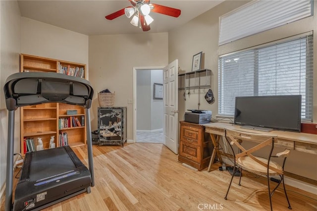 office featuring ceiling fan, baseboards, and wood finished floors