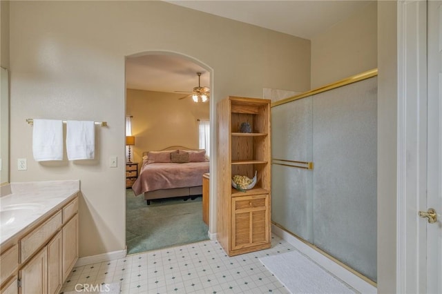 full bath featuring ceiling fan, a stall shower, ensuite bathroom, tile patterned floors, and vanity