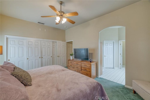 bedroom featuring visible vents, carpet floors, baseboards, arched walkways, and a closet