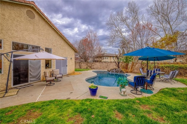 view of swimming pool with a fenced in pool, a lawn, a fenced backyard, and a patio area