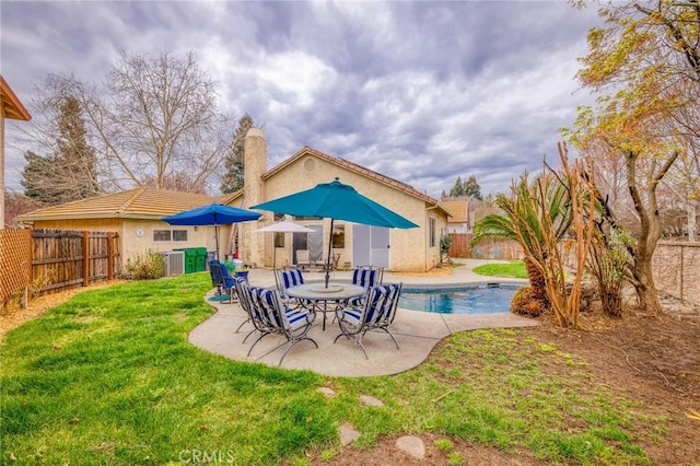 rear view of house featuring central AC unit, a yard, a fenced backyard, stucco siding, and a patio area