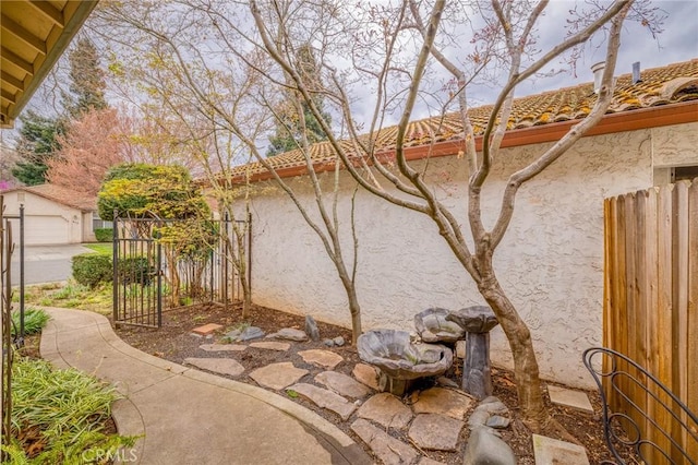 exterior space featuring an outbuilding and fence