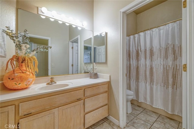 bathroom featuring tile patterned floors, toilet, a shower with shower curtain, and vanity