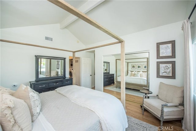 bedroom featuring beamed ceiling, high vaulted ceiling, and wood-type flooring