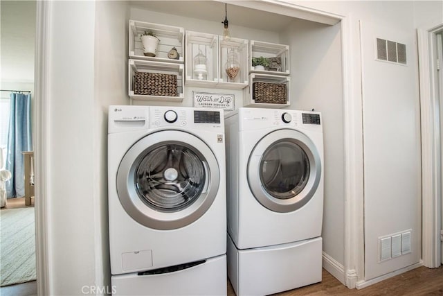 washroom featuring washer and dryer and hardwood / wood-style floors