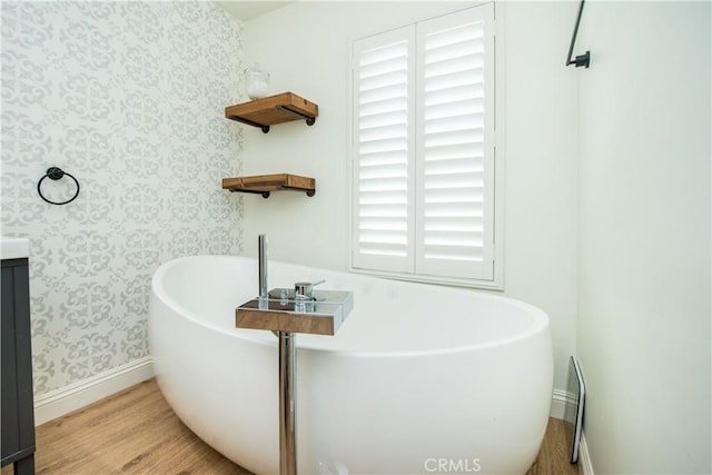 bathroom featuring a tub to relax in and hardwood / wood-style floors