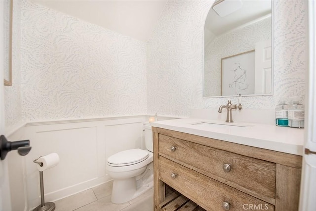 bathroom featuring toilet, vanity, and tile patterned flooring