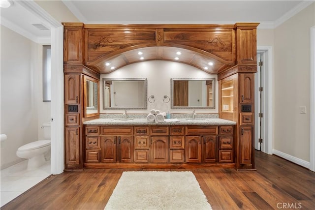 bathroom featuring lofted ceiling, wood finished floors, toilet, and baseboards