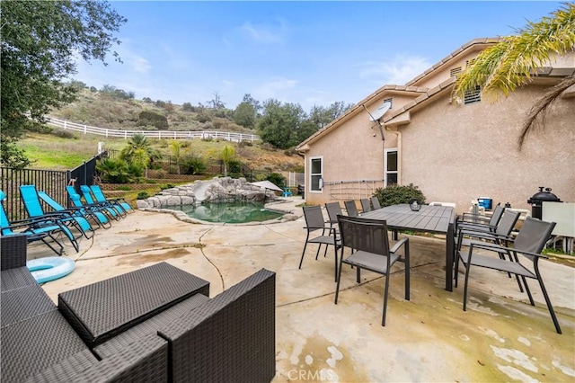 view of patio / terrace featuring a fenced in pool and fence