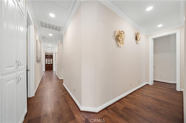 hallway with baseboards, visible vents, dark wood-style flooring, and crown molding