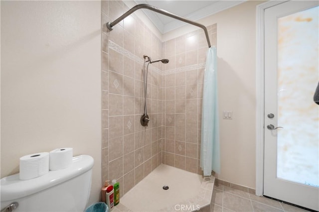 full bathroom with a stall shower, tile patterned flooring, crown molding, and toilet