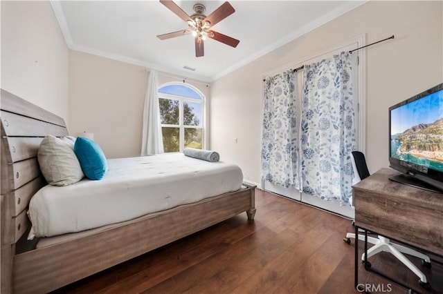 bedroom with ornamental molding, visible vents, ceiling fan, and wood finished floors