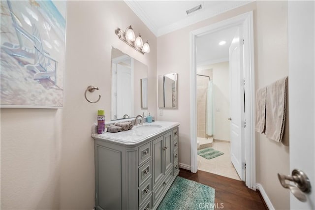 bathroom with wood finished floors, vanity, visible vents, a shower with curtain, and crown molding