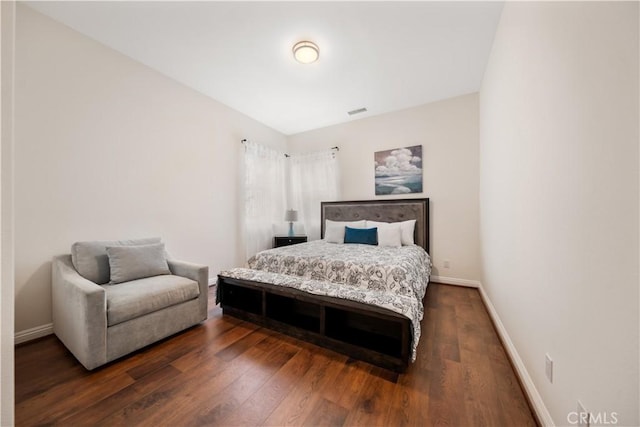 bedroom featuring dark wood-style floors, visible vents, and baseboards