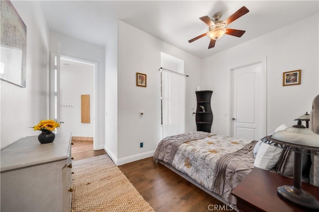 bedroom featuring dark wood finished floors, baseboards, and ceiling fan