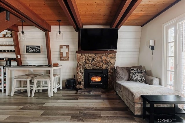 living area featuring wood walls, beamed ceiling, wooden ceiling, and dark hardwood / wood-style floors