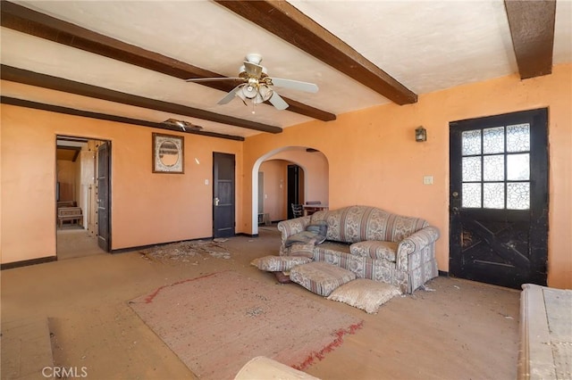 living room featuring beamed ceiling and ceiling fan