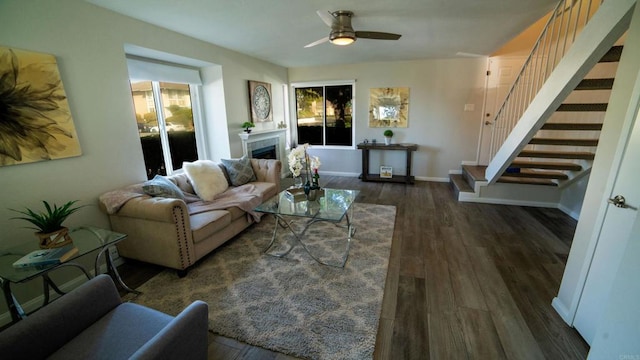 living room with ceiling fan and dark wood-type flooring