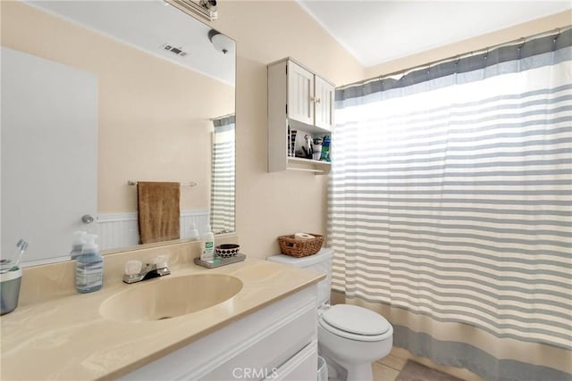 bathroom with vanity, toilet, and tile patterned floors