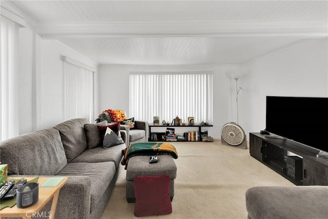 carpeted living room with beamed ceiling