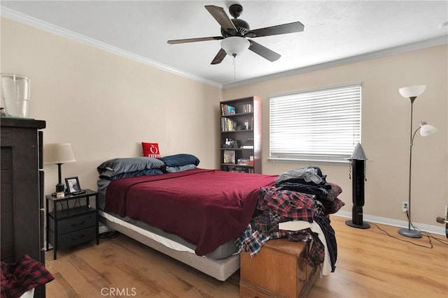 bedroom featuring ceiling fan, hardwood / wood-style flooring, and crown molding