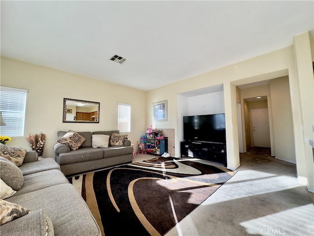 living room featuring visible vents and carpet flooring