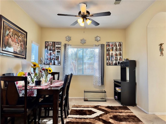 dining area with light carpet, plenty of natural light, and baseboards