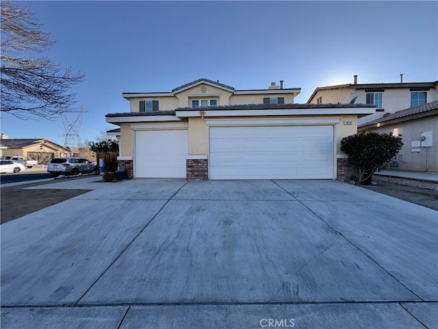 view of front of home featuring driveway, stone siding, a garage, and stucco siding