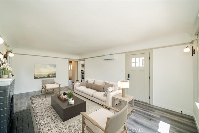 living area with a wall unit AC and wood finished floors