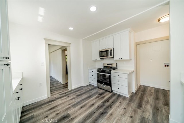 kitchen featuring stainless steel appliances, recessed lighting, light countertops, white cabinetry, and wood finished floors