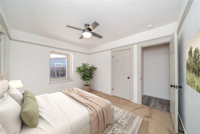 bedroom with ceiling fan, carpet, and baseboards