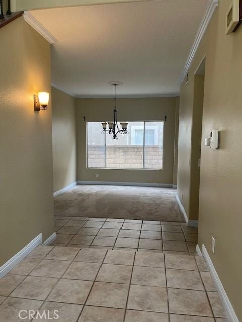unfurnished dining area with an inviting chandelier, light tile patterned floors, visible vents, light carpet, and ornamental molding