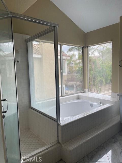 full bath featuring plenty of natural light, marble finish floor, and a shower stall