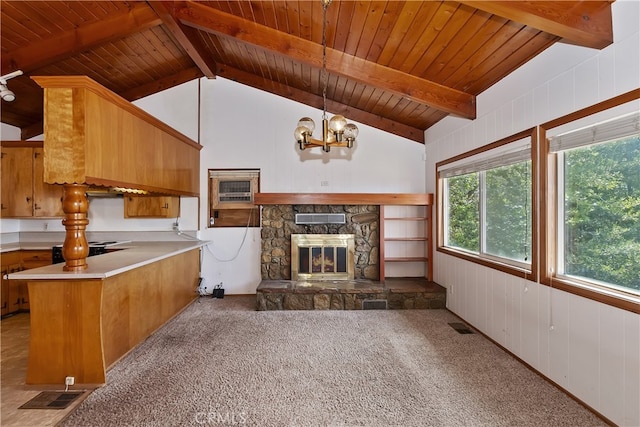 unfurnished living room with vaulted ceiling with beams, a notable chandelier, wooden ceiling, a fireplace, and light carpet