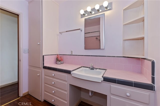 bathroom featuring vanity, tasteful backsplash, and wood-type flooring