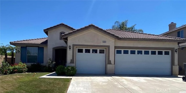 mediterranean / spanish home with a garage