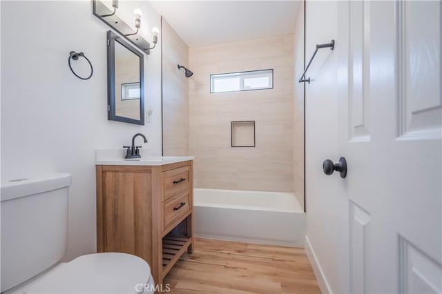 full bathroom featuring tub / shower combination, vanity, toilet, and wood finished floors