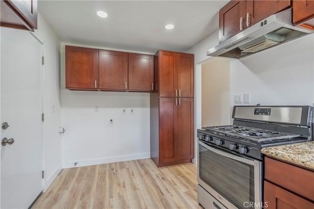 kitchen with stainless steel gas stove, baseboards, light wood-style floors, under cabinet range hood, and recessed lighting