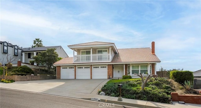 view of front of home with a garage and a balcony