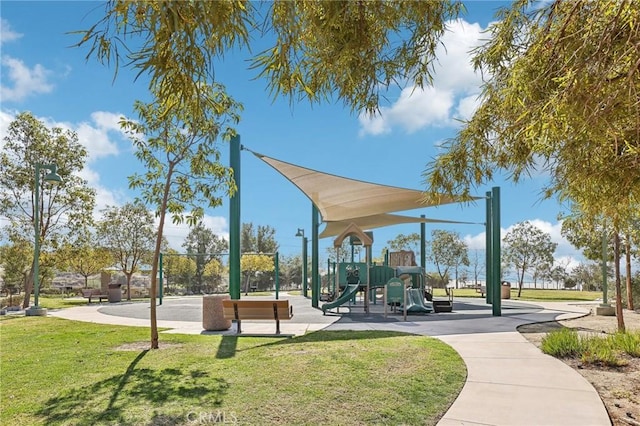 view of home's community with playground community and a yard