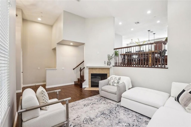 living room featuring recessed lighting, visible vents, a fireplace, and wood finished floors