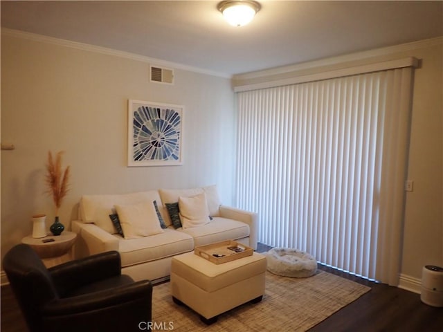 living room featuring hardwood / wood-style flooring and ornamental molding