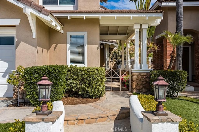 property entrance with stucco siding