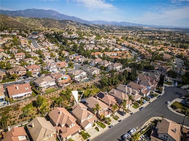 drone / aerial view featuring a residential view and a mountain view