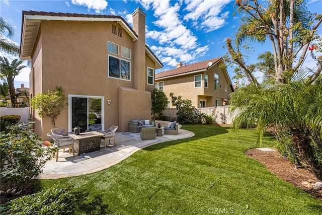 rear view of house featuring fence, a patio, an outdoor living space, and stucco siding