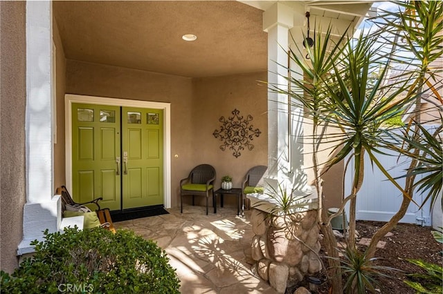 view of exterior entry with stucco siding