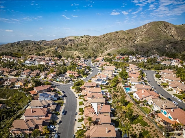 drone / aerial view featuring a residential view and a mountain view