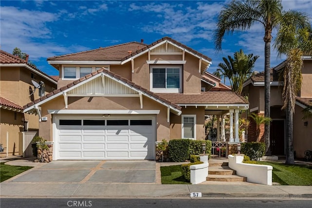 view of front of house featuring concrete driveway, an attached garage, a tiled roof, and stucco siding