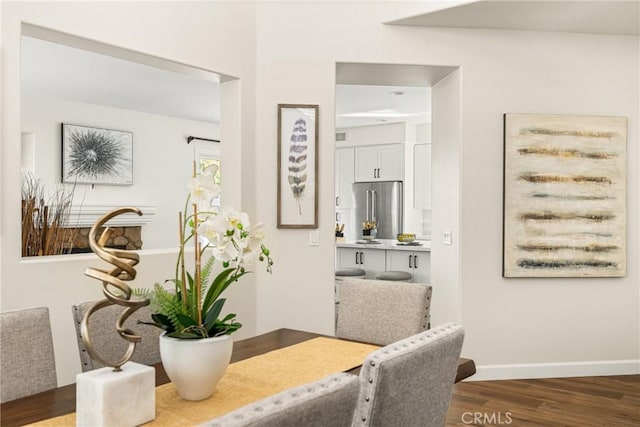 dining room with wood finished floors and baseboards