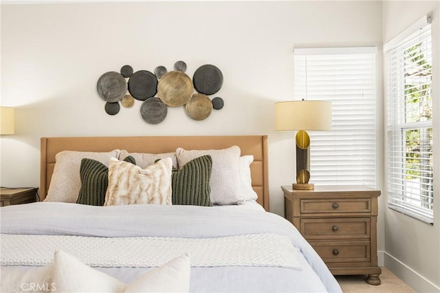 carpeted bedroom featuring baseboards